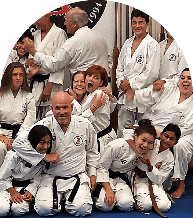 Playful martial artists grouped on dojo mat